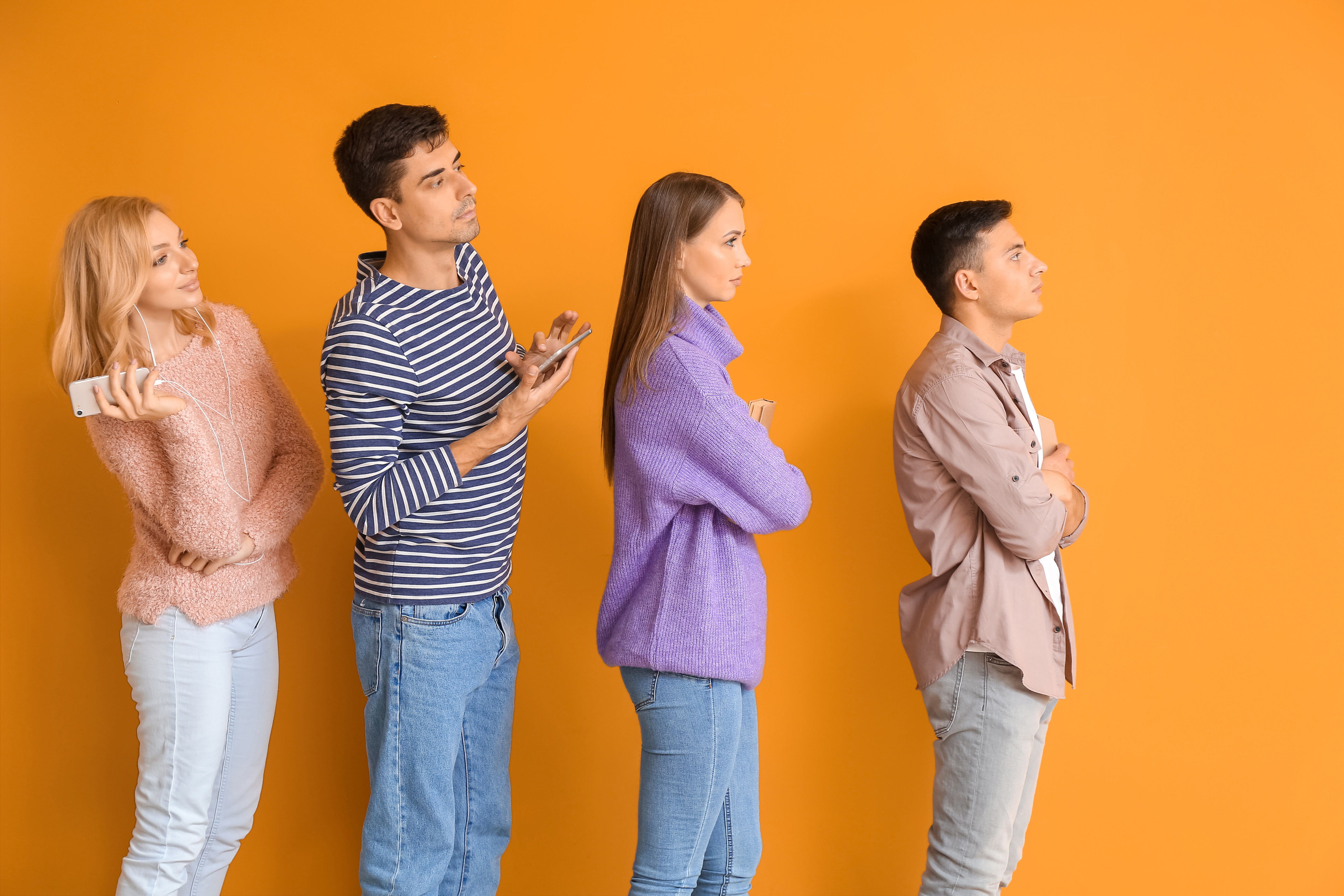 Young People Waiting in Line on Orange Background